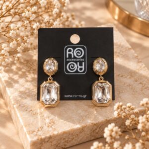 RO Accessories Crystal Elegance χρυσά κρεμαστά σκουλαρίκια με διάφανη οβάλ και ορθογώνια πολυεδρική πέτρα.