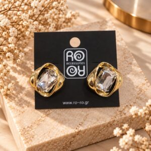 RO Accessories Crystal Embrace χρυσά σκουλαρίκια με μεγάλη διάφανη ορθογώνια πέτρα και γυαλιστερές μεταλλικές καμπύλες.
